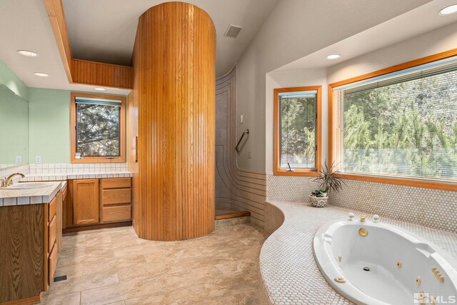 full bathroom with vanity, a whirlpool tub, visible vents, and recessed lighting
