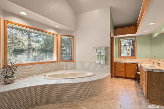 bathroom with recessed lighting, a bath, tile patterned floors, and vanity