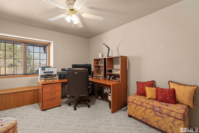 home office with a ceiling fan and light colored carpet