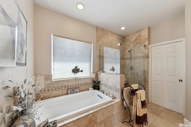 bathroom with a bath, tile patterned flooring, and a stall shower