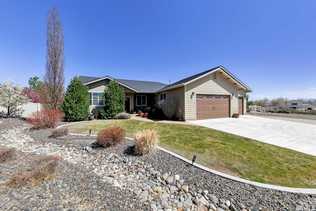 ranch-style home with fence, concrete driveway, a front yard, and a garage