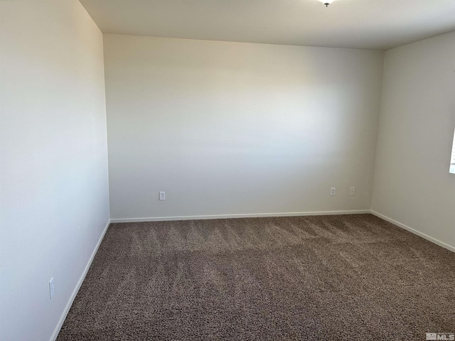 unfurnished room featuring baseboards and carpet