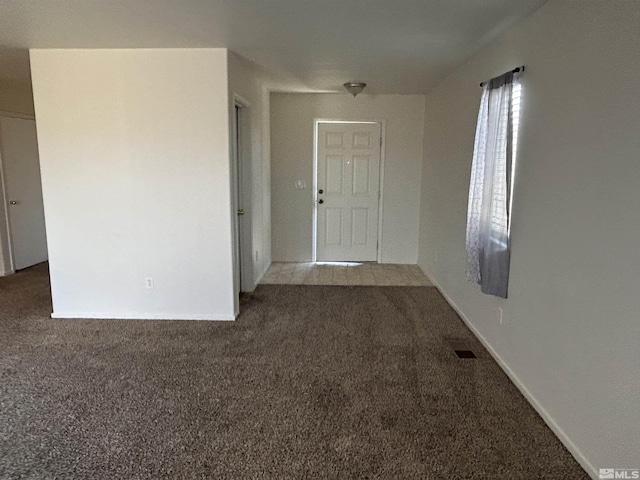 spare room featuring carpet flooring and visible vents
