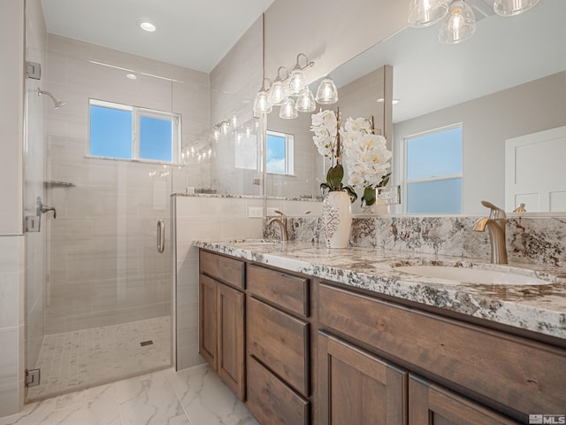 full bath featuring a stall shower, a sink, and plenty of natural light