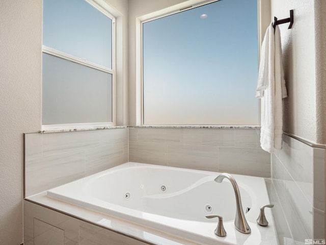 bathroom with a tub with jets