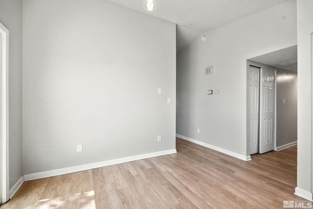 unfurnished room featuring light wood finished floors and baseboards