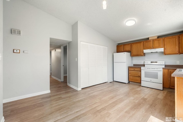 kitchen with brown cabinetry, light wood-style floors, white appliances, lofted ceiling, and under cabinet range hood