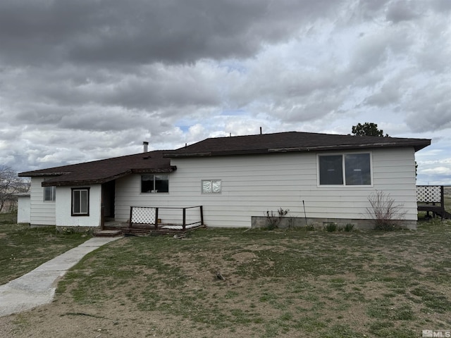 back of house featuring a lawn