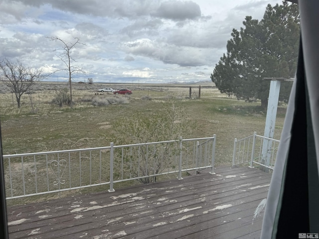 wooden deck featuring a rural view