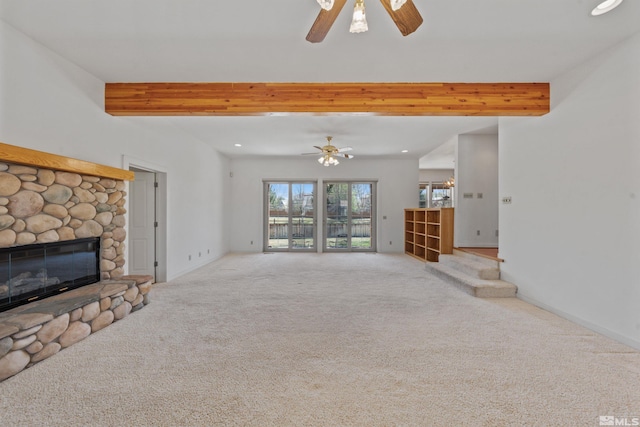 unfurnished living room featuring recessed lighting, carpet, a ceiling fan, beamed ceiling, and a fireplace
