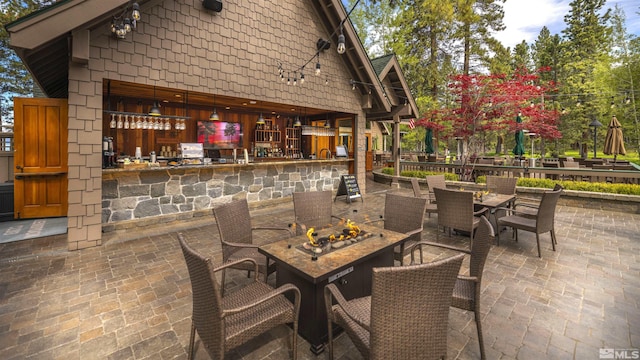 view of patio / terrace with an outdoor fire pit and outdoor dining space