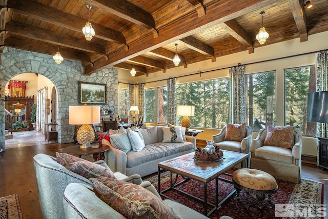 living area featuring plenty of natural light, arched walkways, wood-type flooring, and wooden ceiling