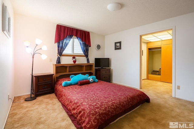 bedroom featuring baseboards and light colored carpet