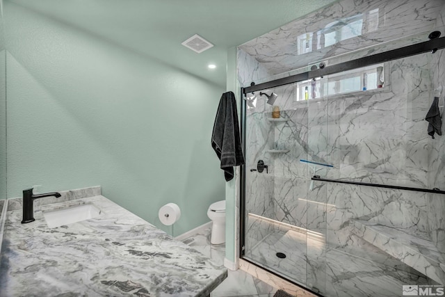 full bathroom featuring marble finish floor, visible vents, toilet, a marble finish shower, and a sink