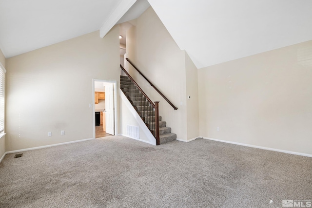 unfurnished living room with visible vents, carpet, beamed ceiling, stairway, and high vaulted ceiling