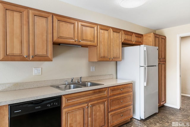 kitchen with light countertops, a sink, freestanding refrigerator, brown cabinetry, and dishwasher