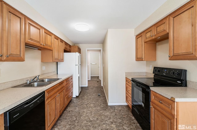 kitchen featuring brown cabinetry, black appliances, a sink, and light countertops