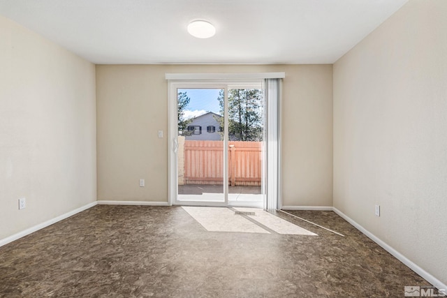carpeted empty room with baseboards