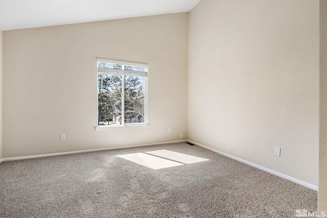carpeted spare room with baseboards