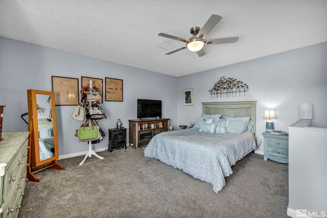 bedroom with carpet floors, a textured ceiling, baseboards, and ceiling fan