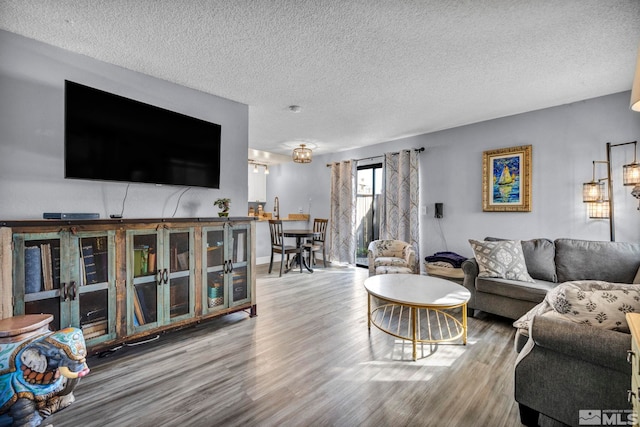 living area featuring wood finished floors and a textured ceiling