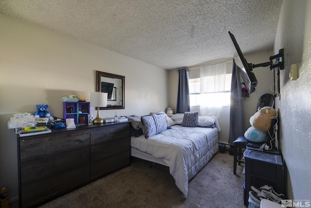 bedroom with dark colored carpet and a textured ceiling