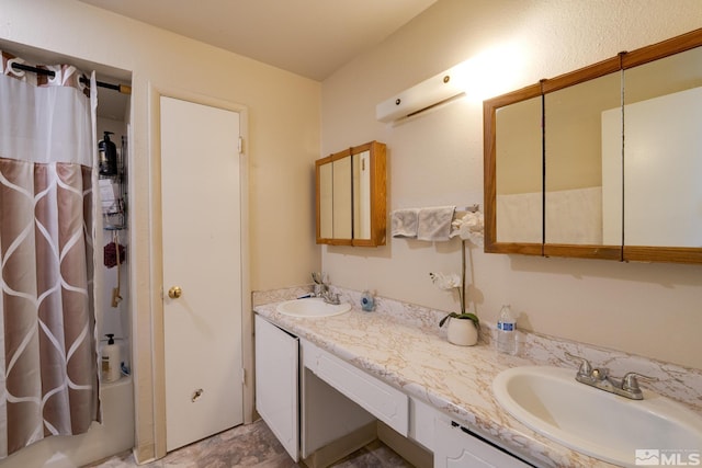 bathroom with shower / bath combo, a sink, and double vanity