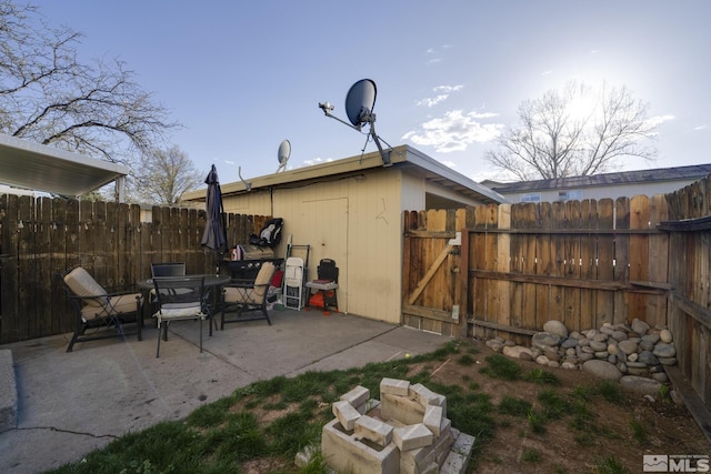 exterior space with fence, a patio area, and a gate