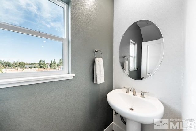 bathroom featuring a healthy amount of sunlight and a sink
