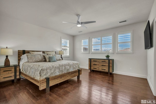 bedroom with ceiling fan, baseboards, dark wood-type flooring, and visible vents