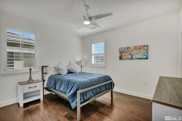 bedroom with visible vents, a ceiling fan, baseboards, and dark wood-style flooring
