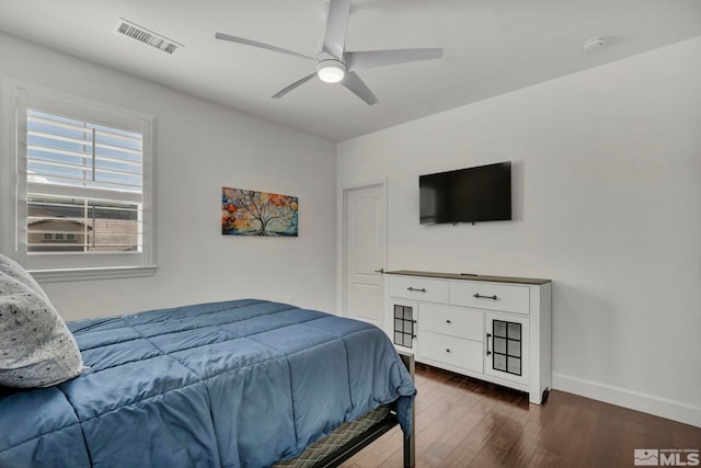 bedroom featuring dark wood finished floors, baseboards, ceiling fan, and visible vents