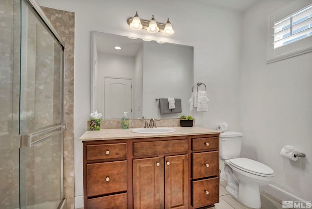 full bathroom featuring baseboards, toilet, vanity, and a stall shower