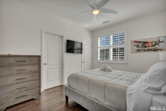 bedroom featuring dark wood finished floors, ceiling fan, and visible vents