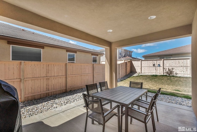 view of patio featuring outdoor dining area and a fenced backyard