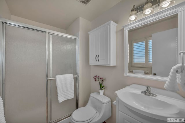 full bath with visible vents, vanity, a shower stall, and toilet