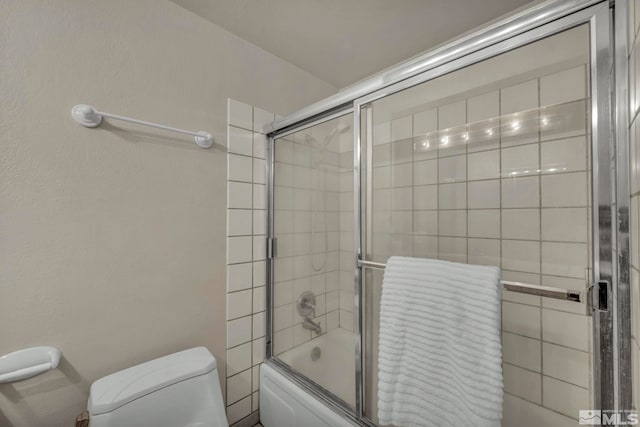 full bathroom with shower / bath combination with glass door and toilet