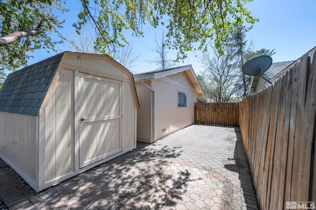 view of shed with a gate and fence