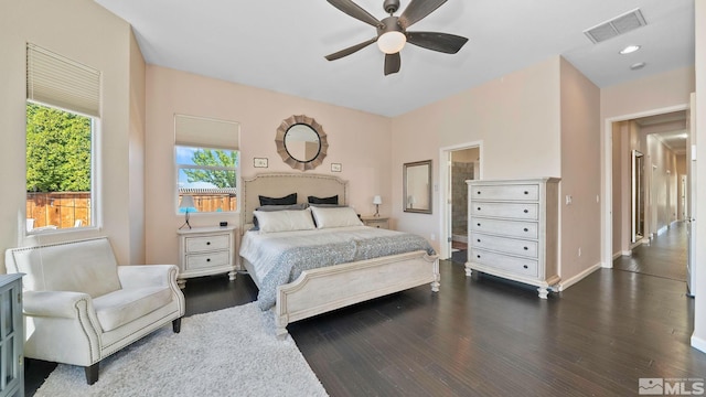 bedroom featuring baseboards, visible vents, dark wood-style floors, and ceiling fan