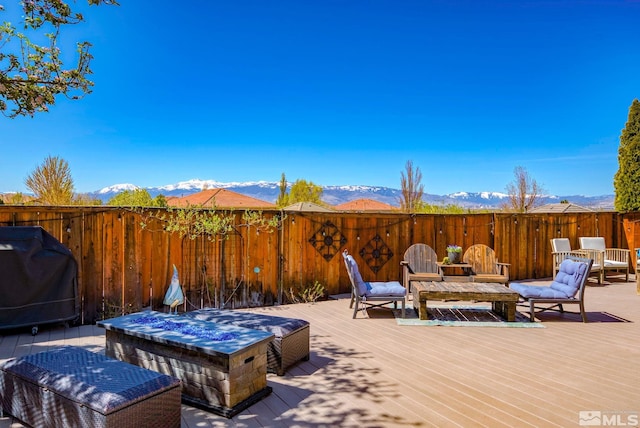 deck with fence, grilling area, and a mountain view