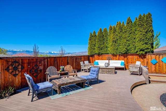 wooden deck featuring an outdoor hangout area and a fenced backyard