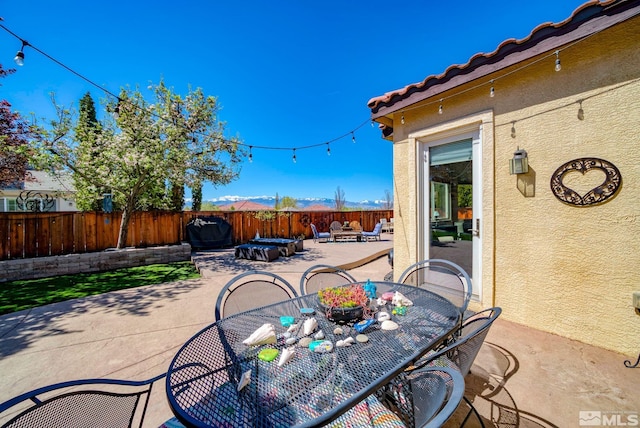 view of patio featuring a fenced backyard and outdoor dining area