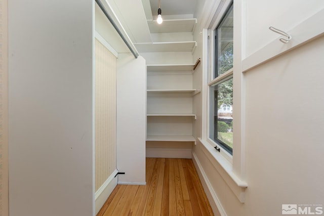 spacious closet with wood finished floors