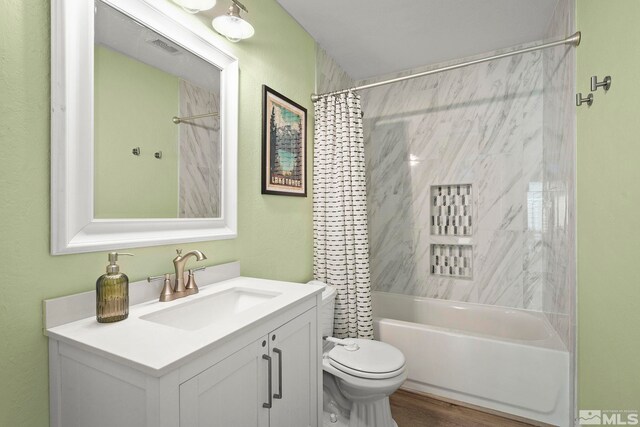 bathroom with visible vents, shower / bath combo, vanity, and toilet
