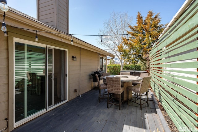 wooden terrace featuring outdoor dining area