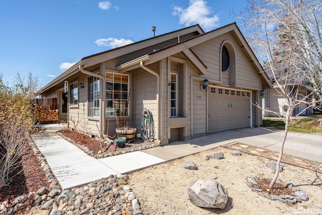 ranch-style home with concrete driveway and an attached garage