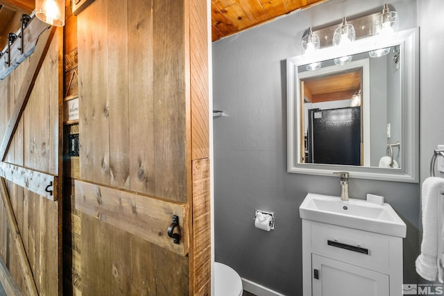 bathroom featuring toilet and vanity