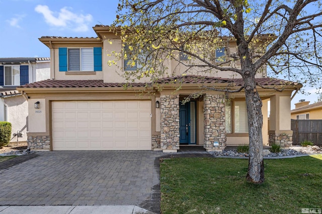 view of front of house featuring a tile roof, stone siding, stucco siding, and decorative driveway