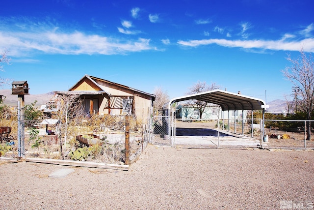 view of front of home featuring a gate, fence, a carport, and driveway