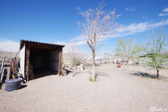 view of yard featuring fence and an outdoor structure